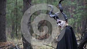 Side view of a girl in the image of Maleficent