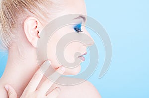 Side view of girl wearing matching nails and make-up