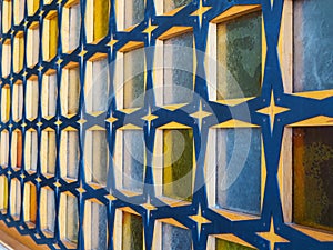 Side view of glass block wall with wooden crossbeams of blue-yellow colors, texture and background concept