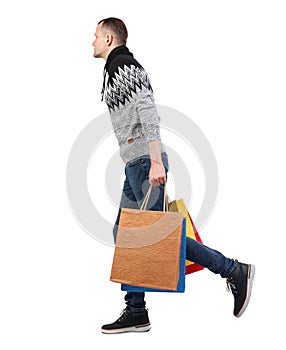 Side view of going man with shopping bags