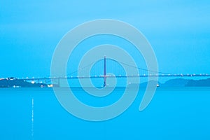 A side view of the Golden Gate Bridge at a blue dawn in San Francisco