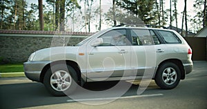 Side view. gray crossover car drives down the street