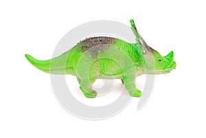 Side view green styracosaurus toy on white background