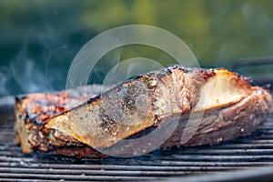 Side view of a grilled beef rib on a barbecue grill