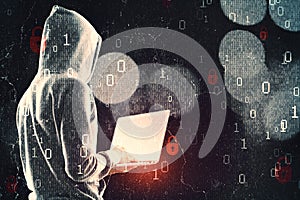 Side view of hacker in hoodie using laptop while standing on abstract hacking background with bokeh circles and binary coding