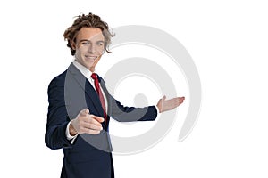 Side view of handsome businessman recommending to side and pointing finger photo