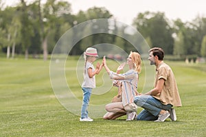 side view of happy family with one child