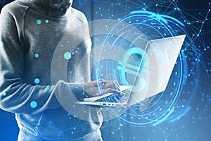 Side view of headless hacker holding laptop computer with creative round euro sign on blurry blue polygonal background. Crypto,