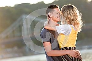 side view of heterosexual couple going to kiss on river beach