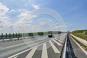 Side view highway on sunny summer day crossing vineyards