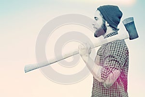 Composite image of side view of hipster with axe on shoulder