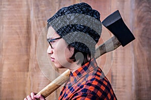 Side view of hipster holding a axe