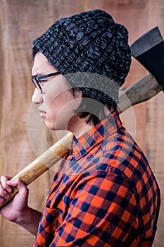 Side view of hipster holding a axe