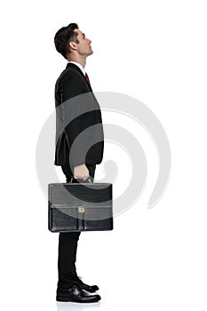 Side view of hopeful businessman looking up