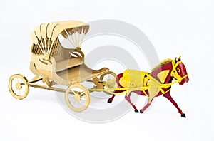 Side view of a horse made of cardboard pulling a carriage on a white background
