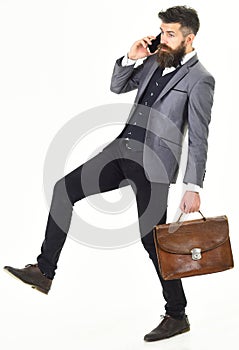 Side view of a hurrying business man talking on the mobile