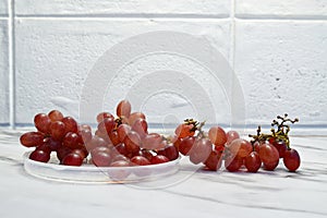 Side view image of grape on the marble table