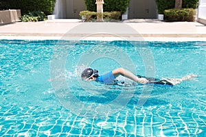 Side view image of happy elderly asian swimming in pool during retirement holiday with relaxation and smiling