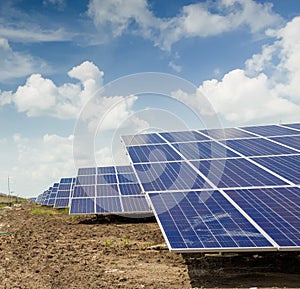 Side view of Installed row of Photovoltaic solar panels / modules at solar power station