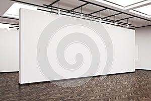 Side view of a large blank wall in an art gallery with dark wood
