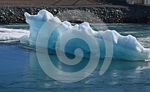 Side view of a large glacier in a bay