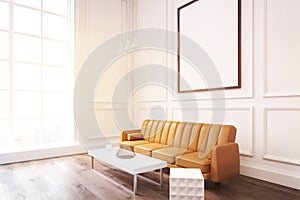 Side view of a living room with poster, brown sofa and a coffee