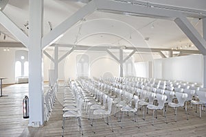 White seats in a bright airy venue photo