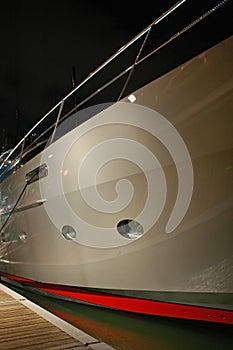 Side view of luxury yacht at night