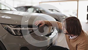 Side view of man buyer, client in casual clothes choosing auto.