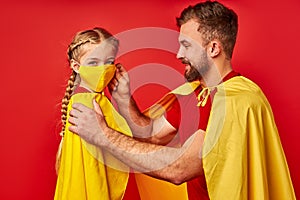 Side view on man and child girl wearing protective mask