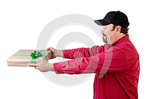 Side view of man giving wrapped present on white