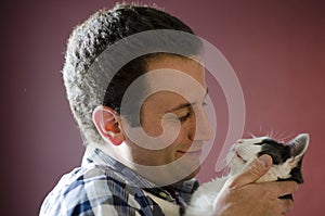 Side view of man and his cat gazing into each other`s eyes.