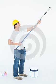 Side view of man painting on white background