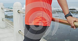 Side view man with prosthetic leg standing at the beach