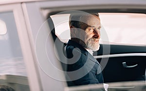 Side view of a man sitting in a car