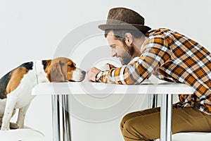 side view of man touching dog nose