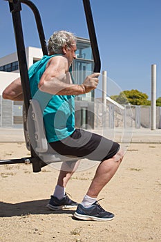 side view of a man training on the street with sports machine