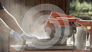 Side view of a man using an angle grinder