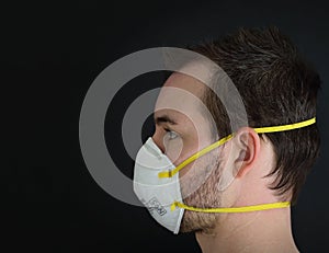 Side View of a Man Wearing an N95 Respirator Dust