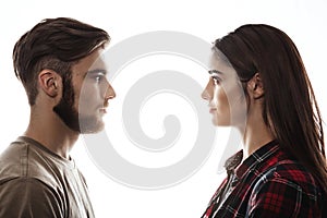 Side view. Man and woman facing each other, eyes open. photo