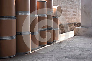 Side view of many old brown paper buckets for reuse on concrete floor in storage area