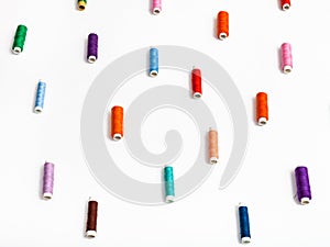 Side view of many spools of sewing thread