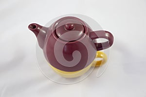 Bicolor ceramic teapot on white background.