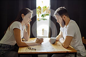 Side view on married couple spending time in the kitchen at weekend