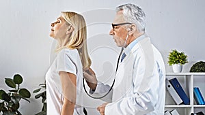 side view of mature doctor examining