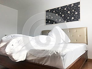 Messy or unmade hotel bed or house bedroom, interior design