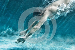 Side view of middle aged man swimming underwater
