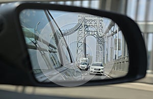 side view mirror view of road with george washington bridge (car, truck, road, traffic, highway)