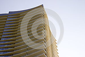 Side view of a modern corporate office building with overhangs in each floor.