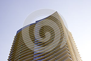 Side view of a modern corporate office building with overhangs in each floor.